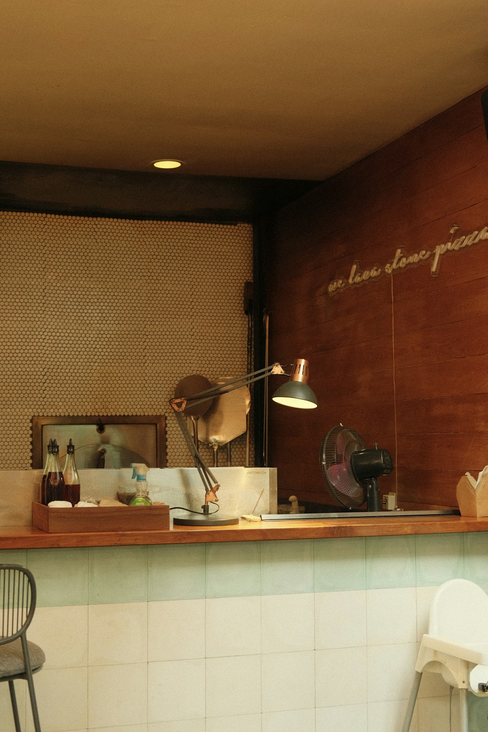 a kitchen with a wood wall