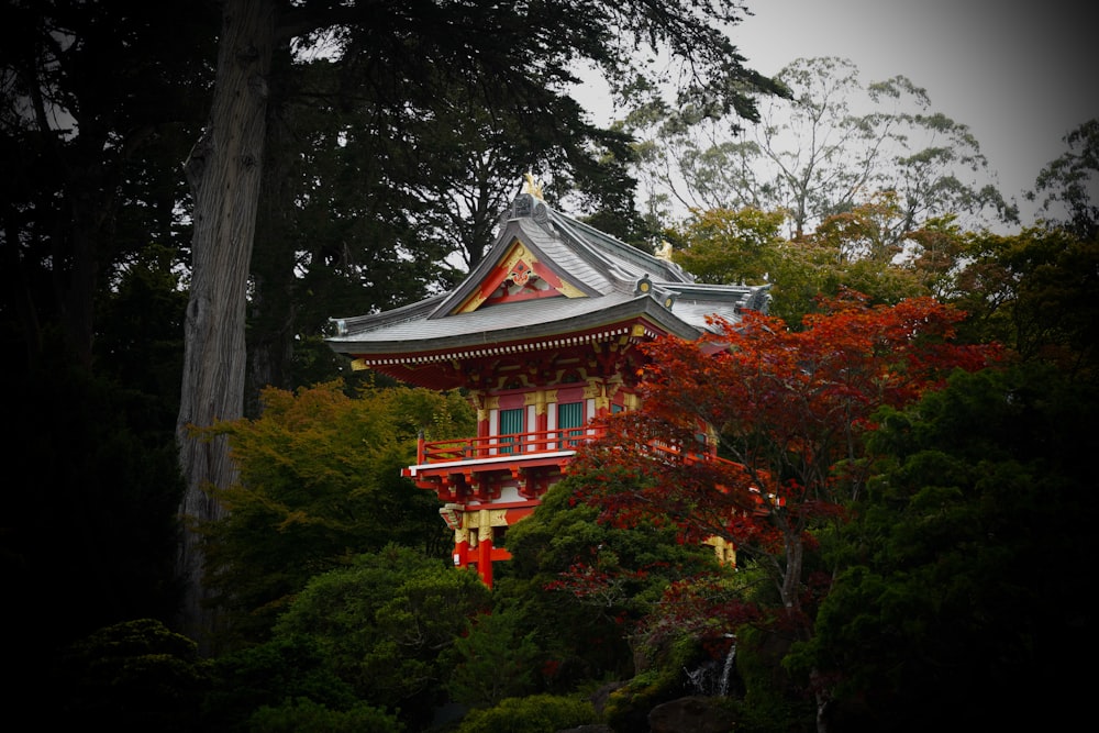 a building with a red roof surrounded by trees