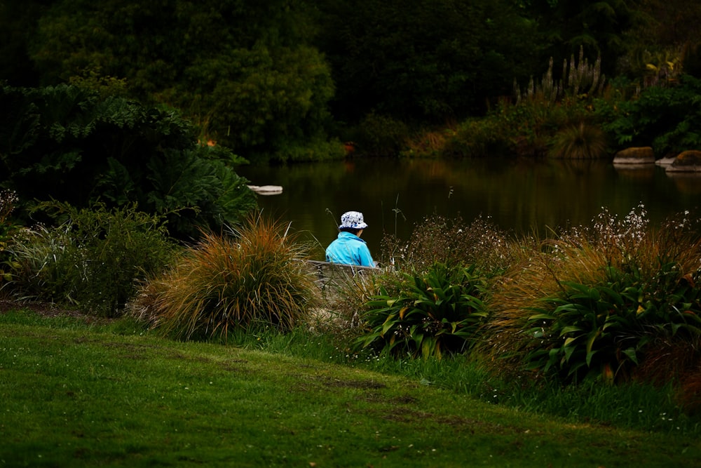 a person sitting in a boat on a river bank