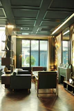 Comfortable deluxe room featuring modern furnishings and a cozy seating area.