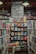 A well-organized bookstore shelf filled with a variety of books. The central section has a display with books displayed with covers facing forward, showcasing titles from different genres and authors. Above the books, there is a large sign featuring the names of famous authors in bold, such as William Shakespeare and Jane Austen. The surrounding shelves are filled with more books arranged side-by-side.