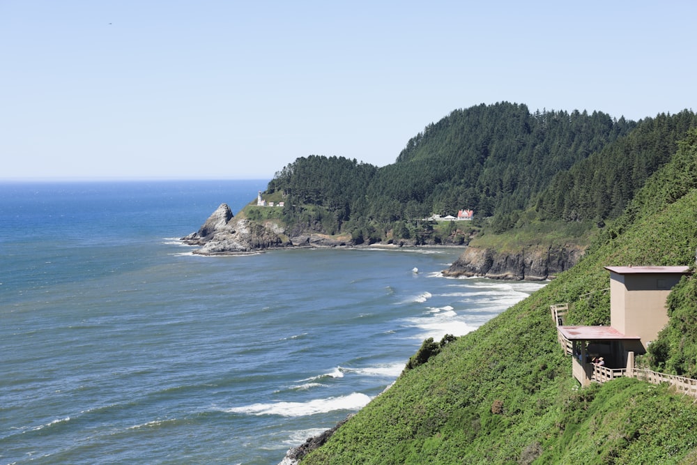 a body of water with a building and trees on the side