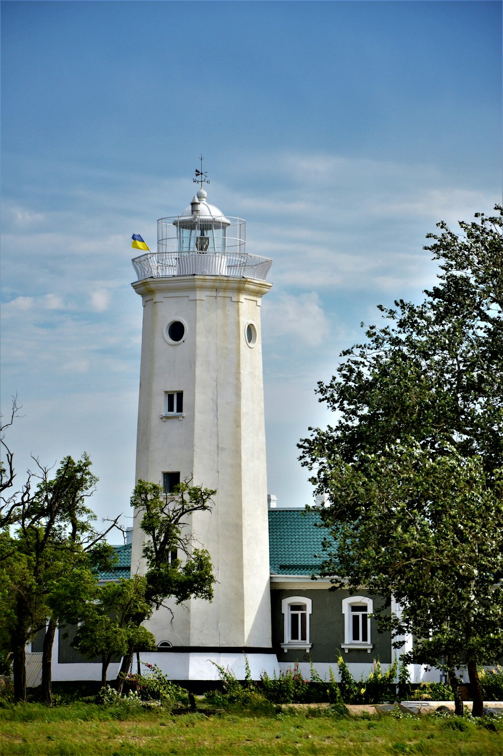 a white tower with a cross on top