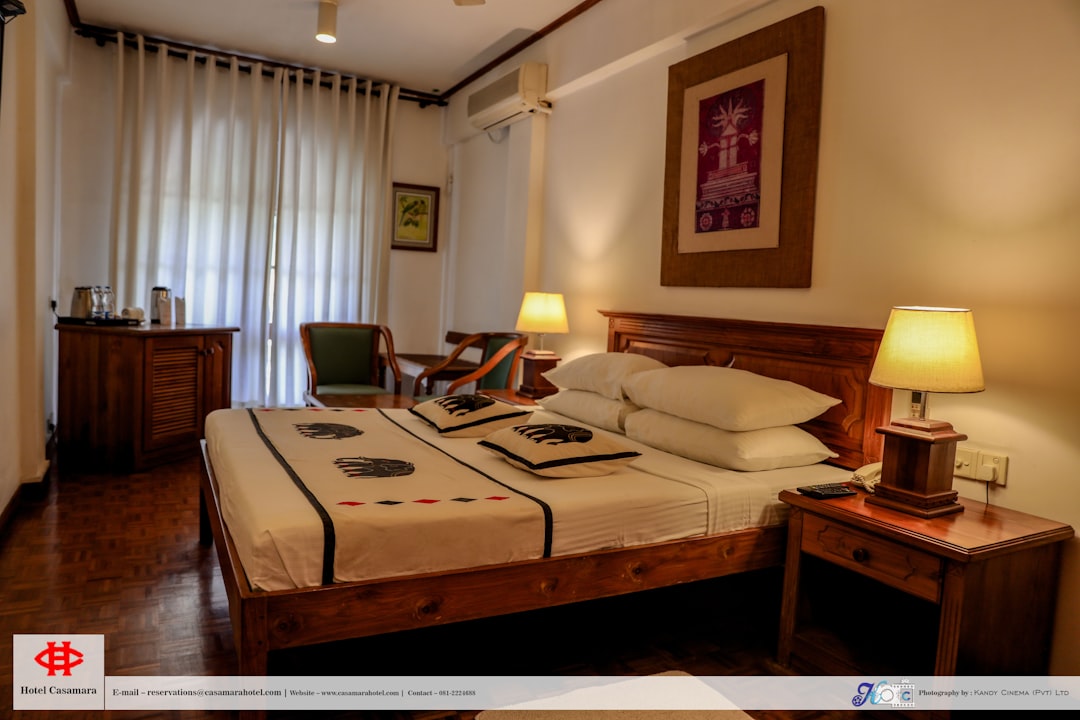 a hotel room with a bed and a desk, Hotel Casamara Kandy - This understated, city center hotel is a 7-minute walk from the Buddhist Temple of the Tooth and a 10-minute walk from Kandy Lake.<p></figure>Featuring hardwood floors, the cosy, casual rooms include satellite TV and free Wi-Fi, as well as minibars. Some add balconies. Room service is available 24/7.</p><p>Breakfast is available for a fee. Amenities include a restaurant, a bar, and a coffee shop. There’s also an outdoor pool.