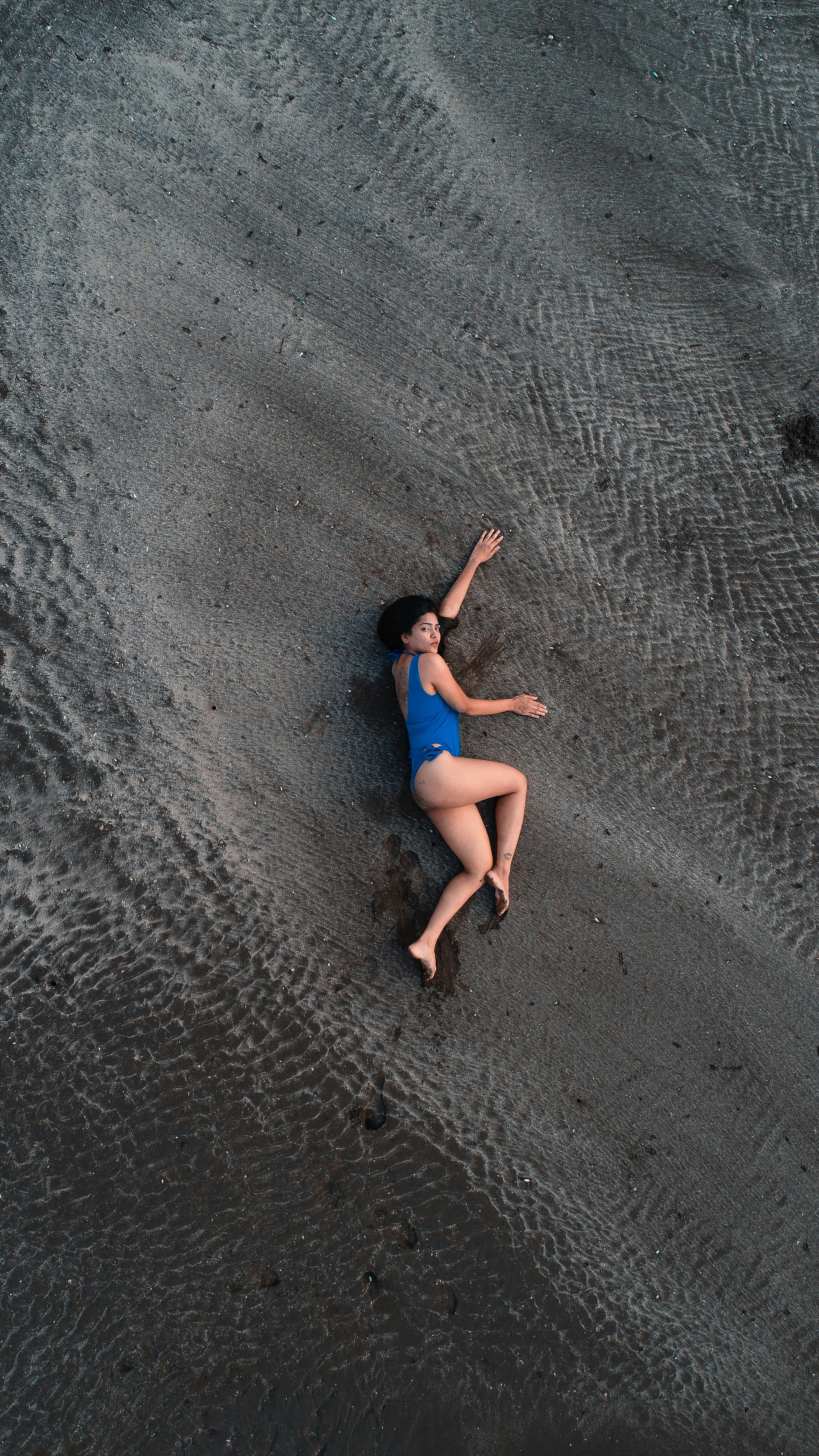 A person in a blue dress sitting on a rock photo – Free Mumbai Image on ...