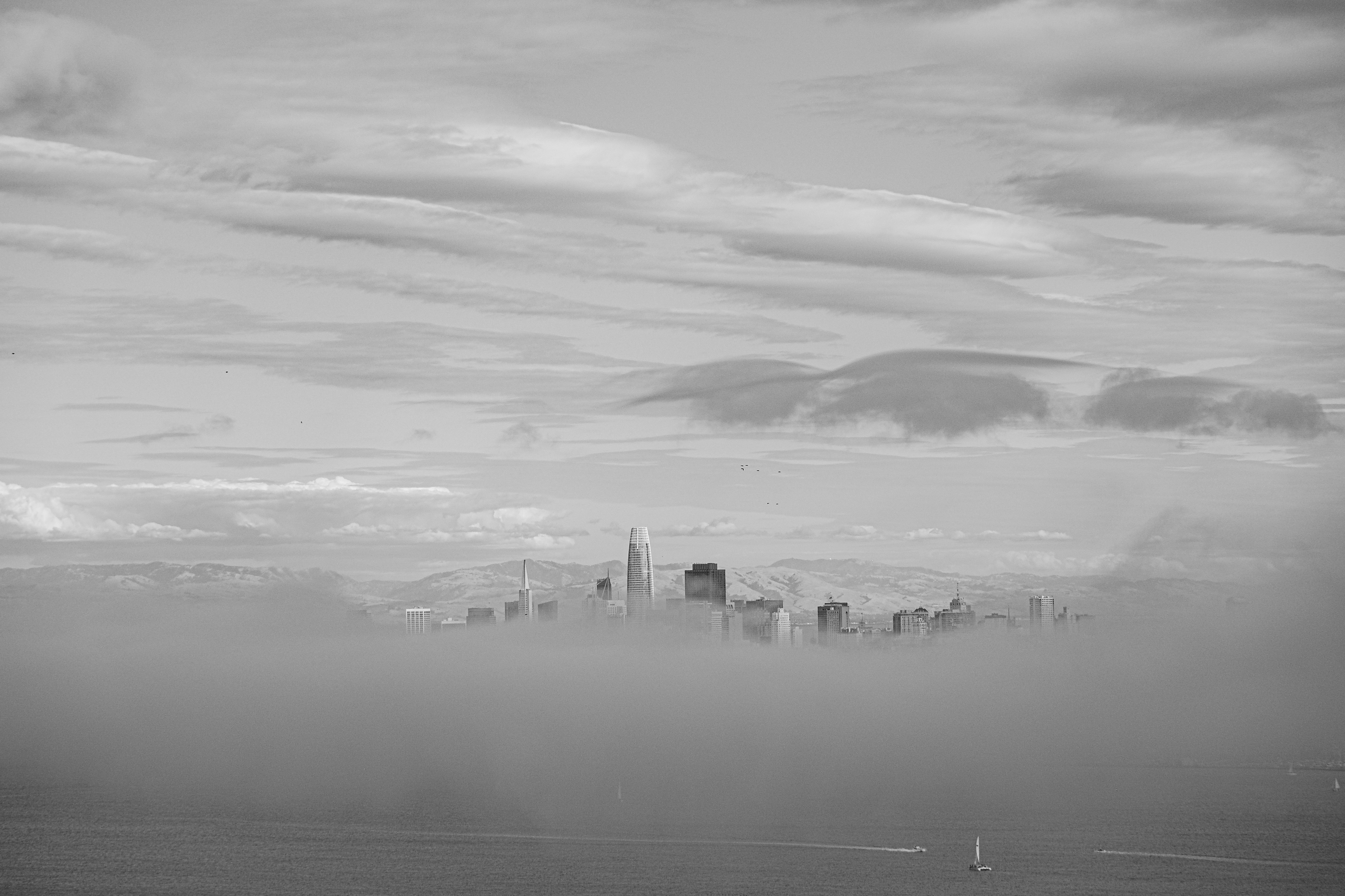 a foggy landscape with a bridge