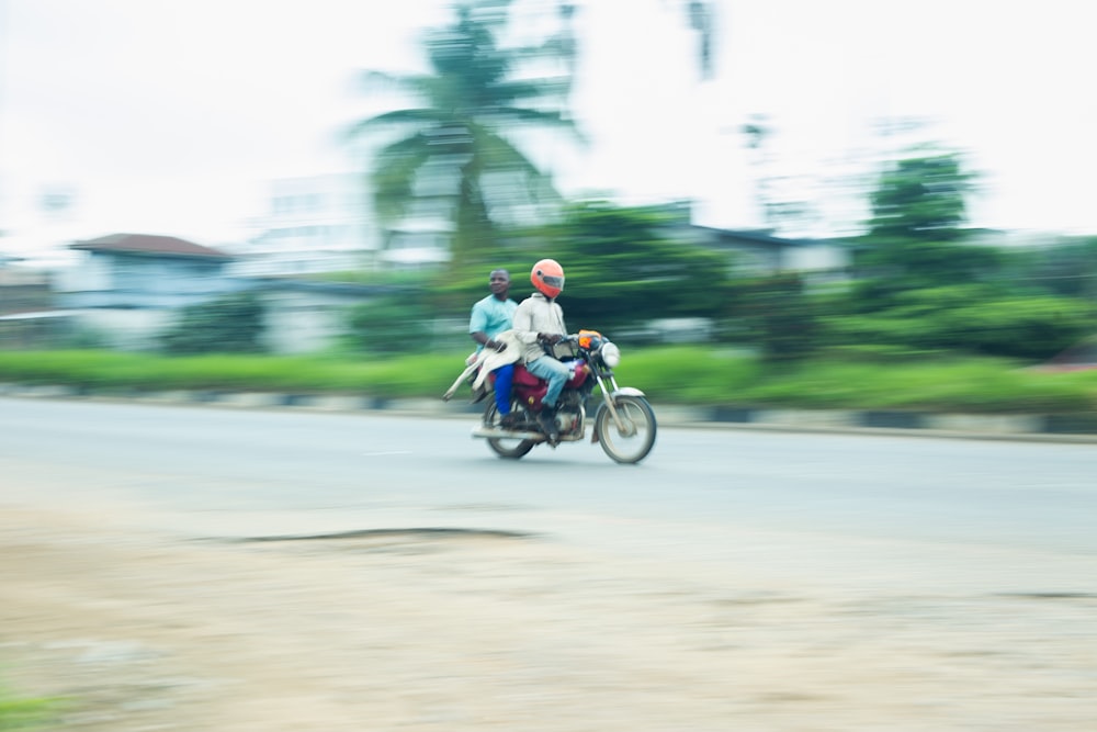 a couple of people riding a motorcycle