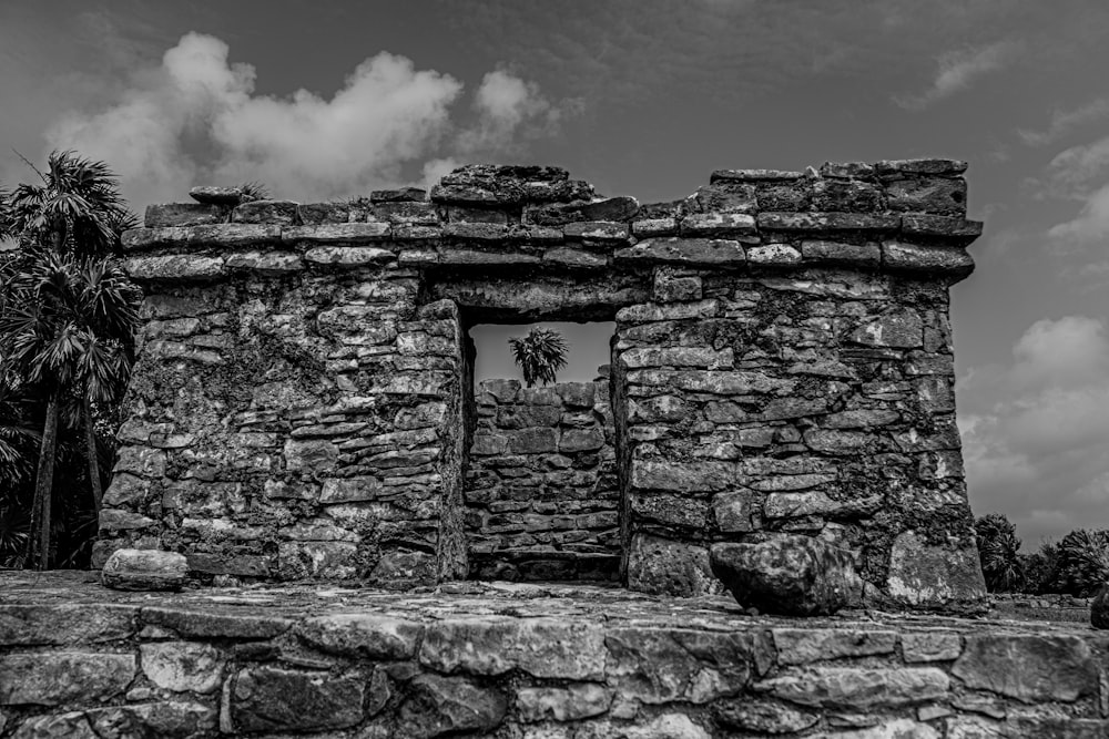 a stone building with a tree in the front