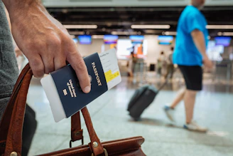 a hand holding a passport for a flight to Egypt.