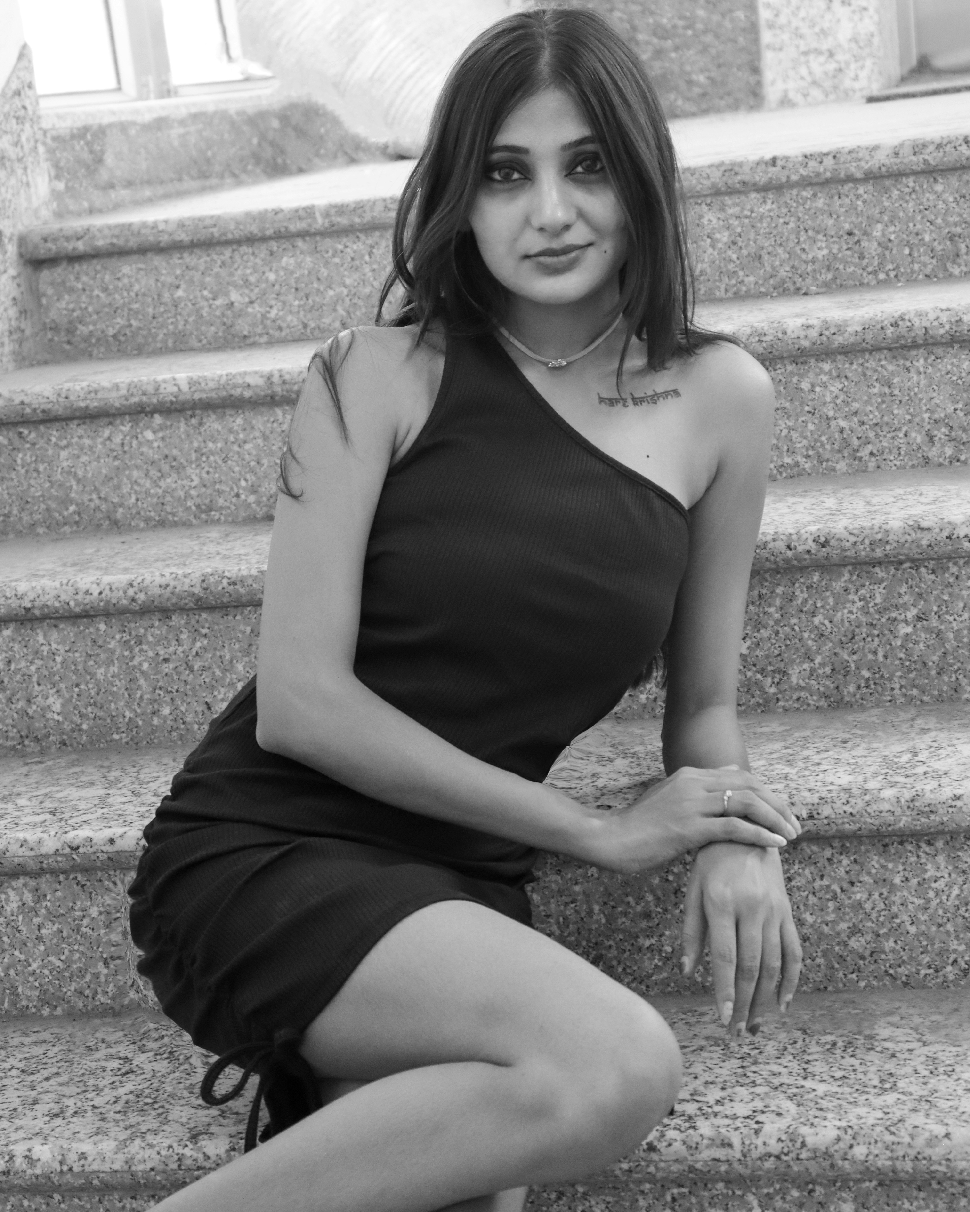 a woman sitting on a stone ledge