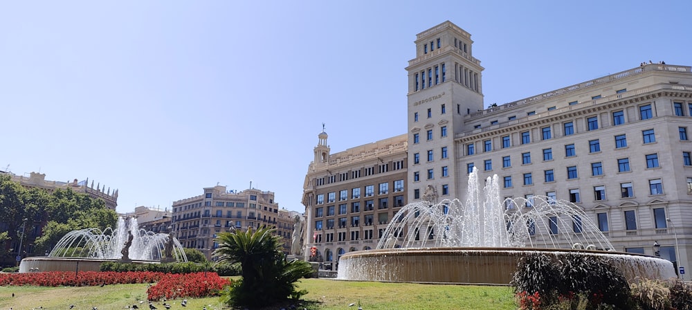 a large building with a fountain in front of it