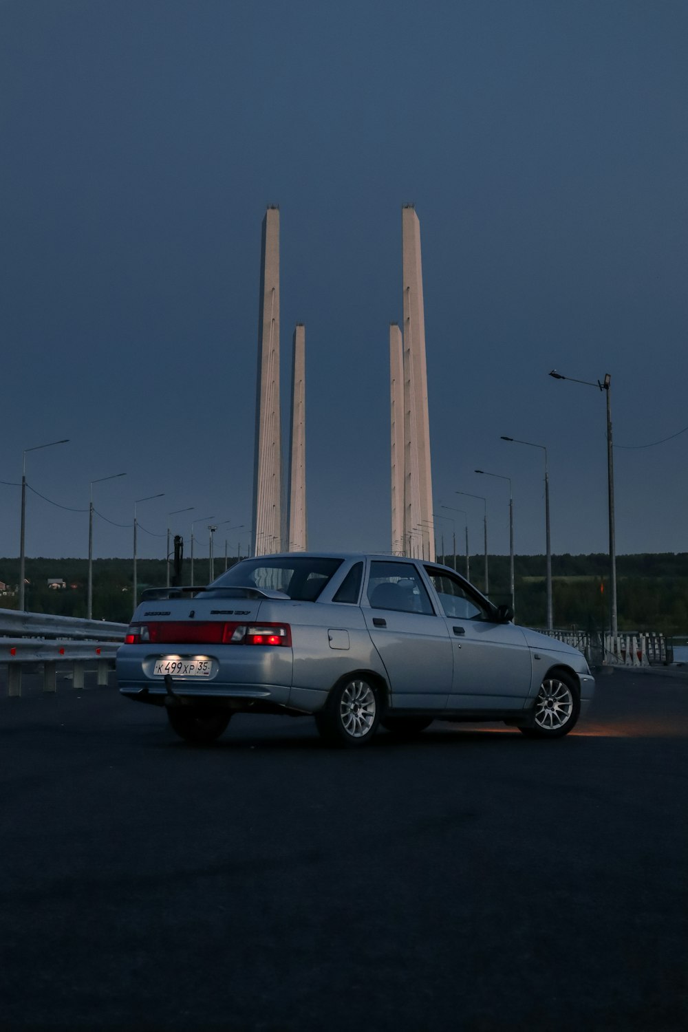 a car parked in front of a row of tall pillars