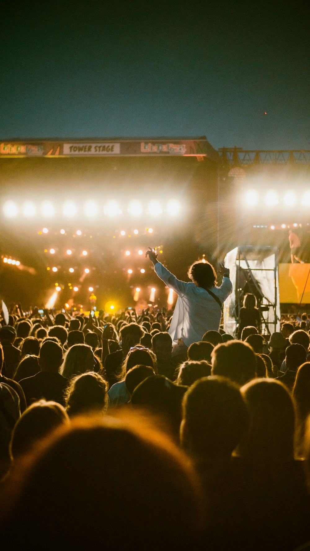 a person on stage with a crowd watching