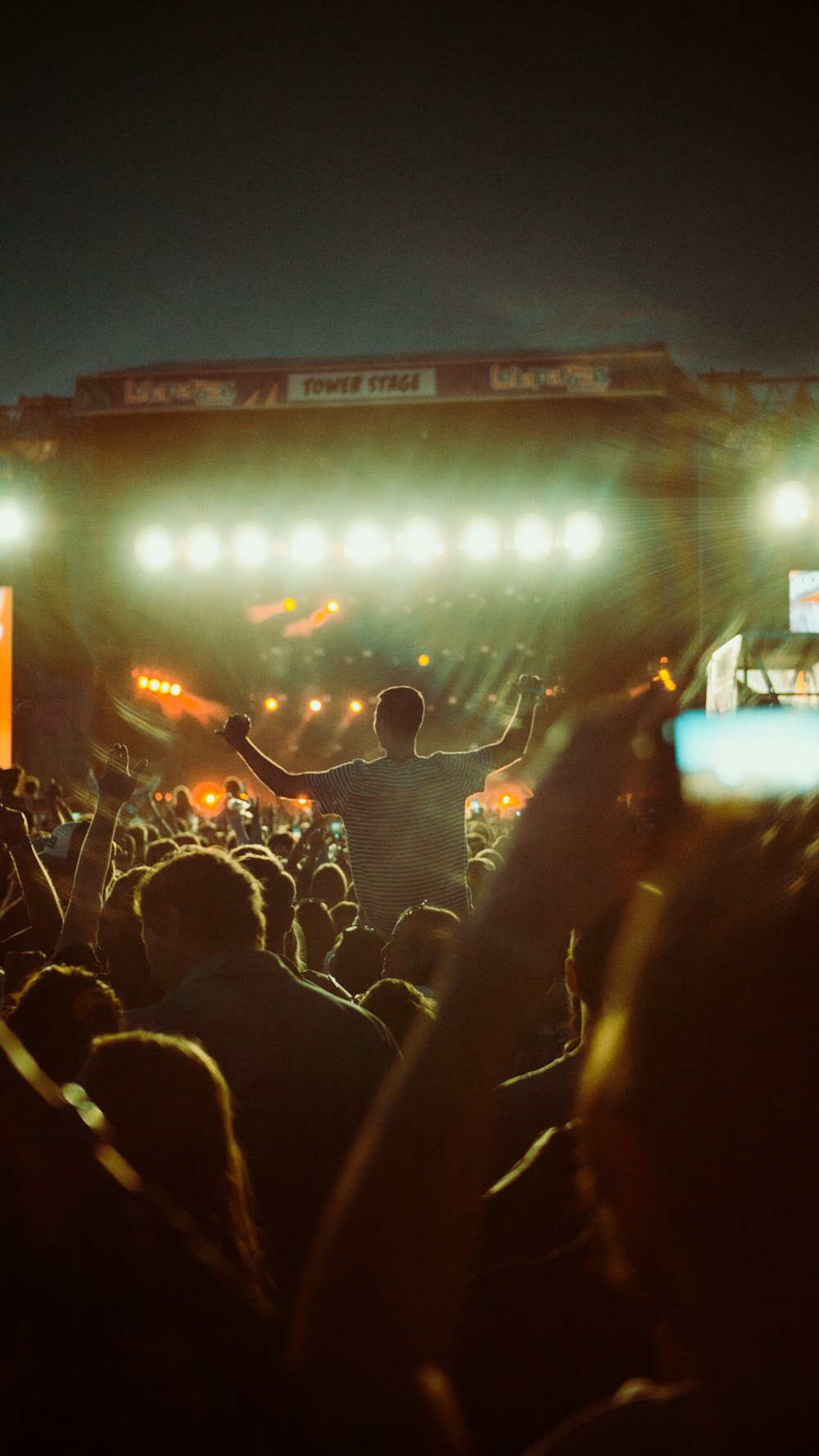 a person on a stage with a crowd watching