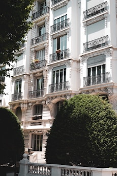 a building with balconies and trees in front of it