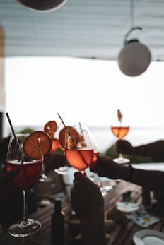 a table with glasses of wine and fruit on it
