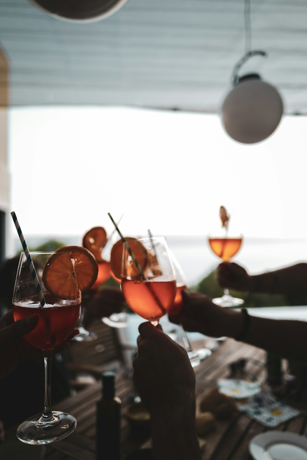 a table with glasses of wine and fruit on it