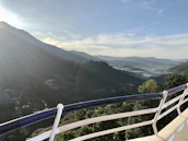 View from the lodge balcony overlooking the misty mountains at sunrise.