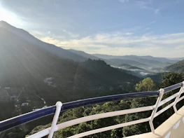 View from the lodge balcony overlooking the misty mountains at sunrise.