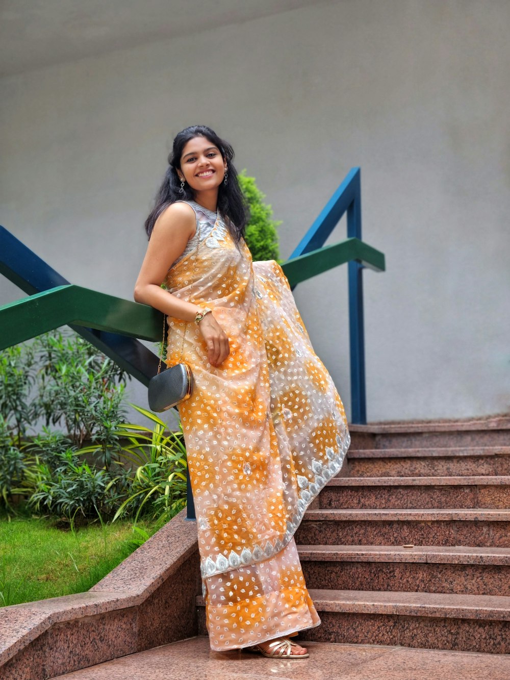 a woman in a dress holding a yellow umbrella