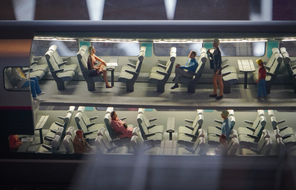 people sitting in chairs in an airport