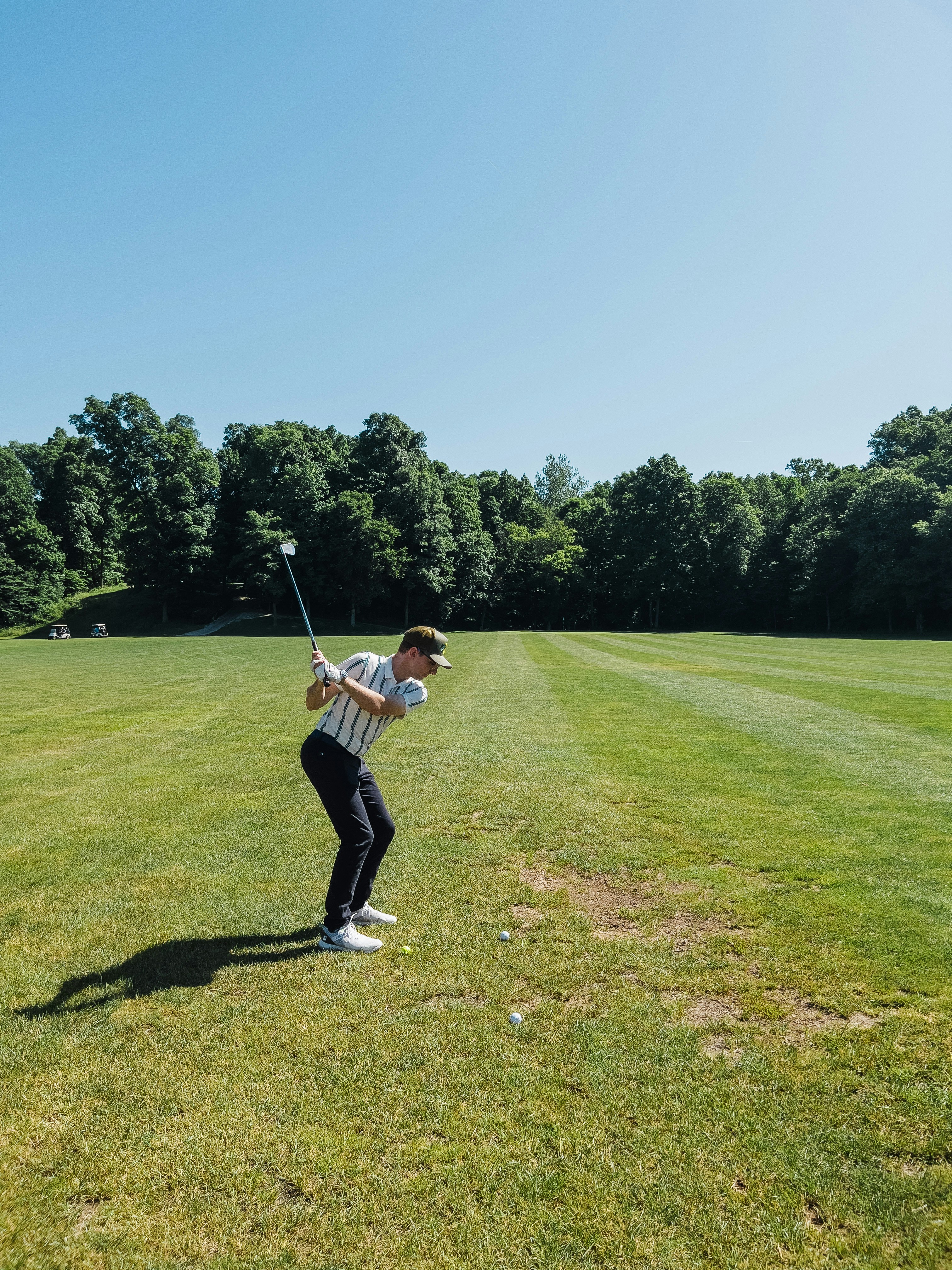 a man swinging a golf club