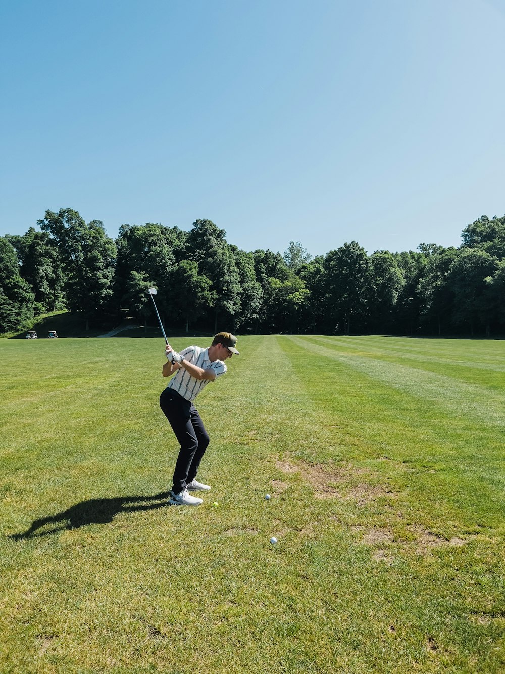 a man swinging a golf club