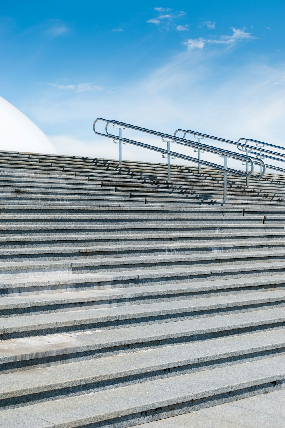 a set of stairs leading up to a blue sky