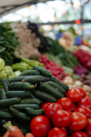 A vibrant display of ripe tomatoes and cucumbers freshly picked.
