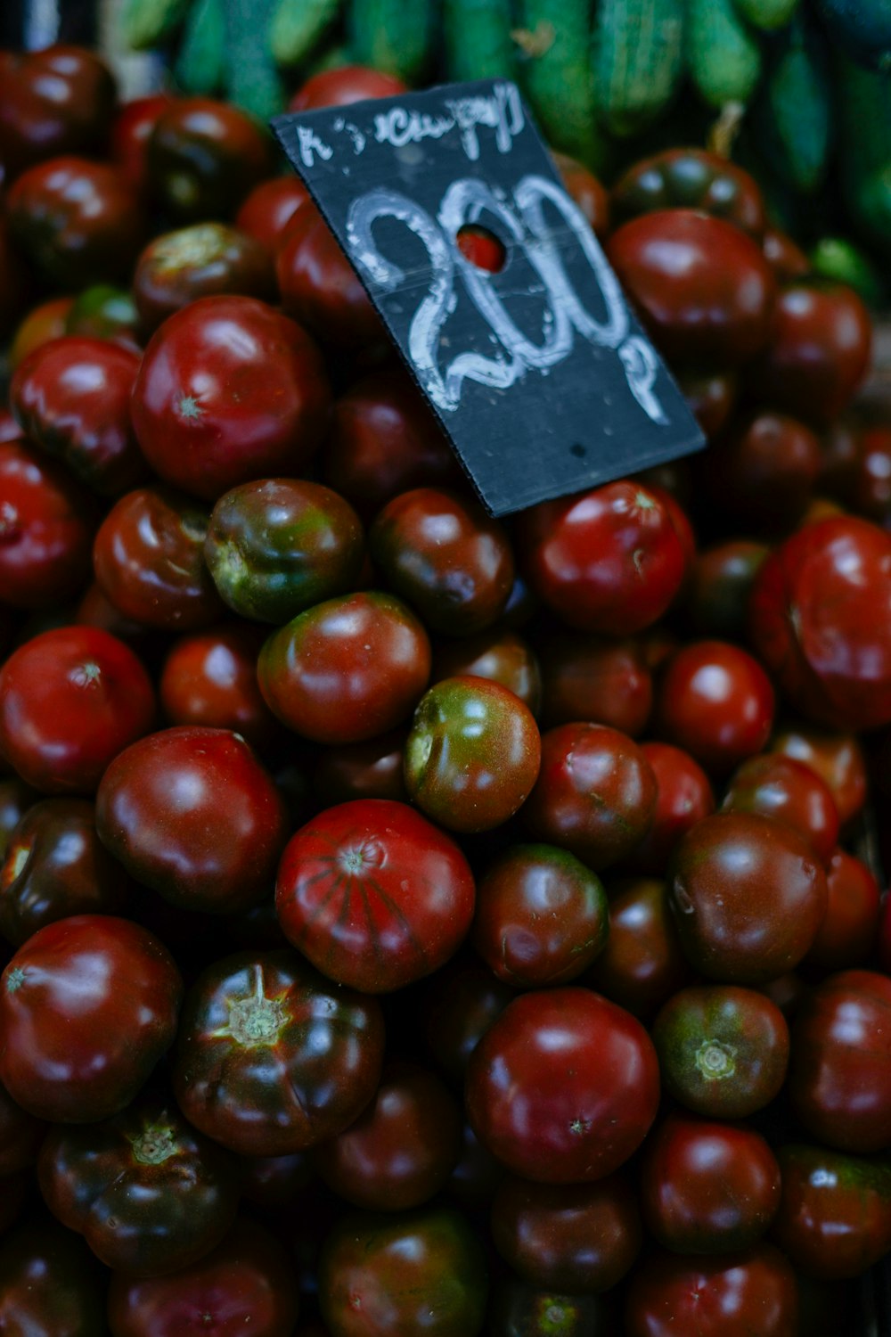 a pile of red and green tomatoes