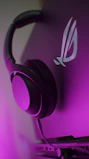 Modern electronics like headphones and smart devices styled with a minimalist purple background.