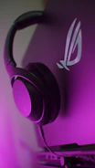 Modern electronics like headphones and smart devices styled with a minimalist purple background.