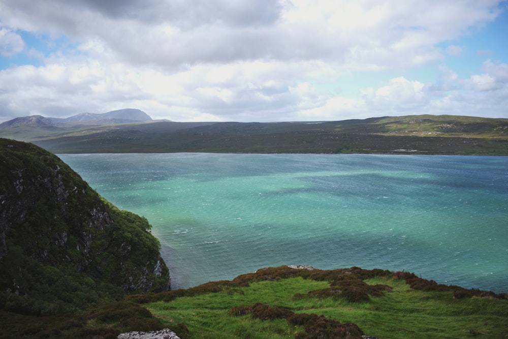 a body of water with hills around it