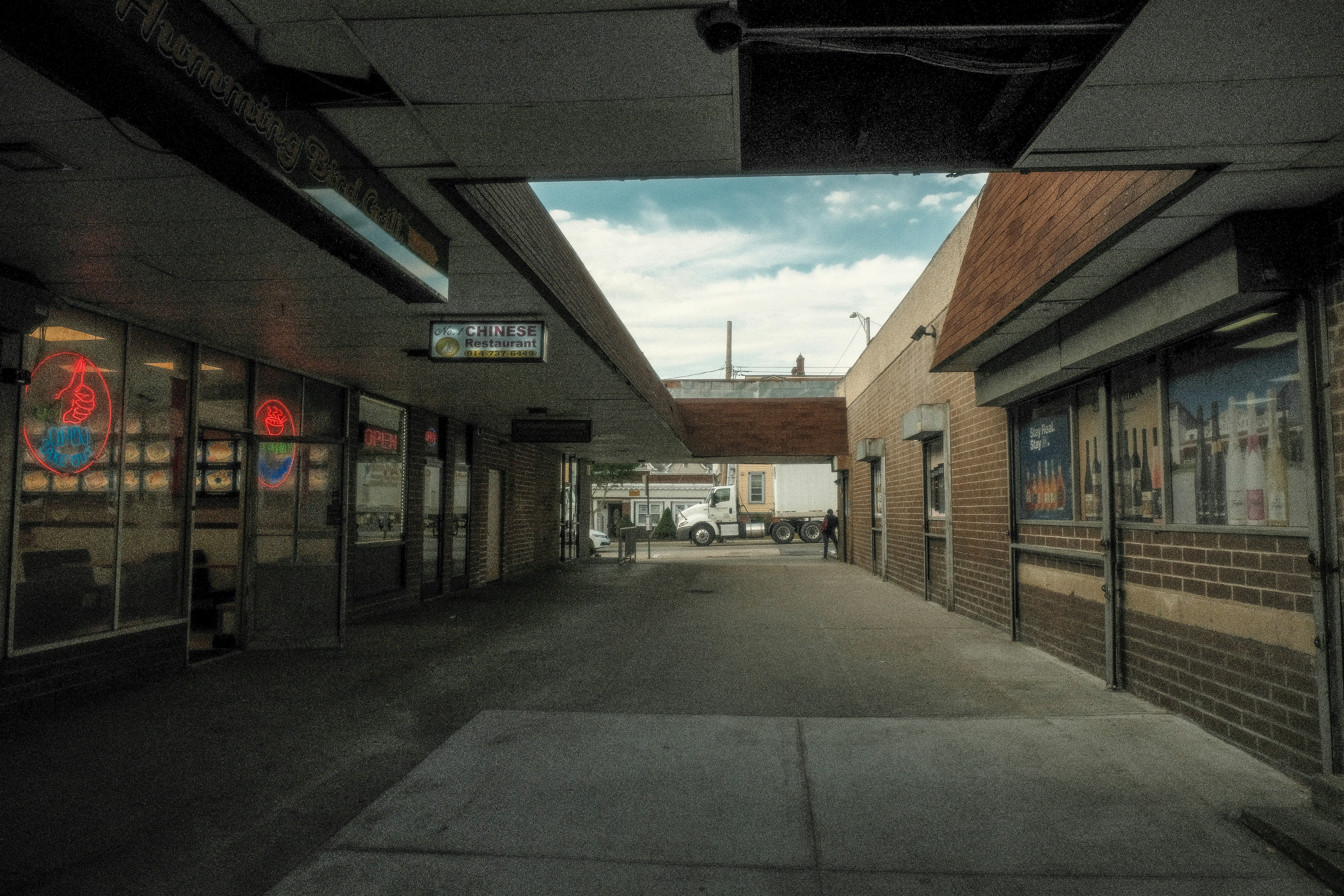 a long road with cars parked on the side
