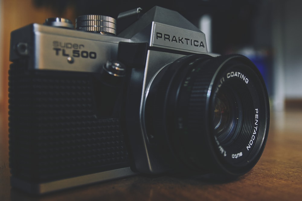 a black camera on a wooden surface