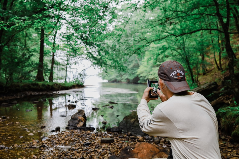 a man taking a picture of a river