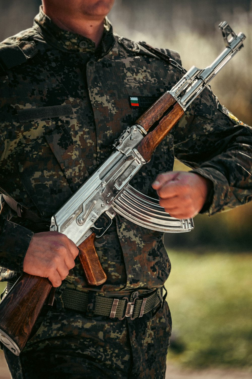 a man wearing a military uniform holding a gun