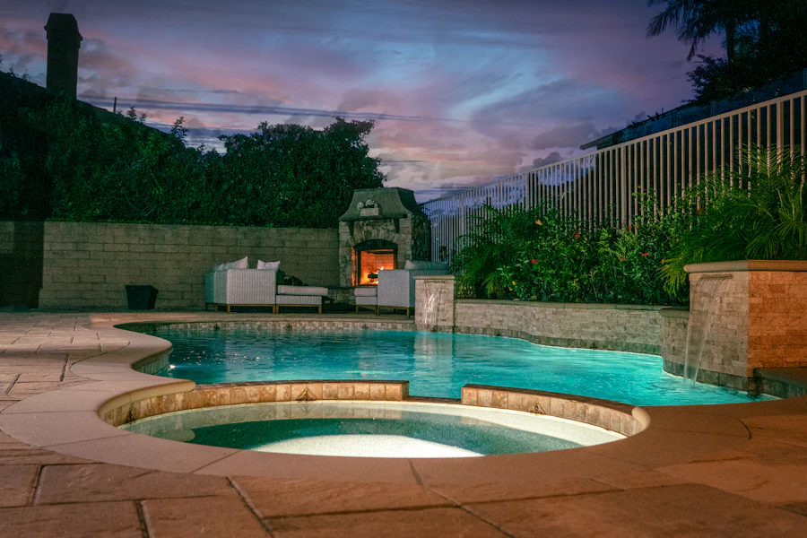 A swimming pool bordered by a stone patio at the West Lake Garden.