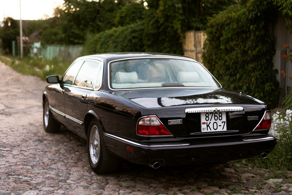 a black car parked on a driveway