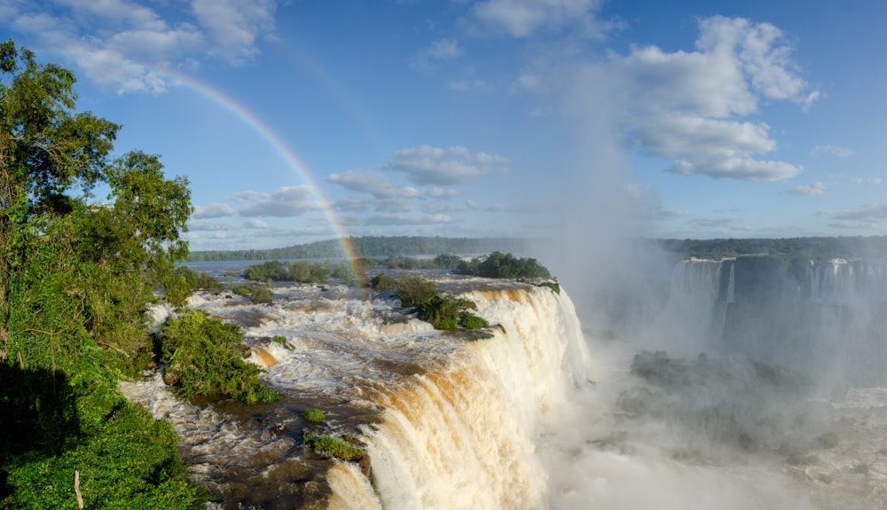 a waterfall with a rainbow