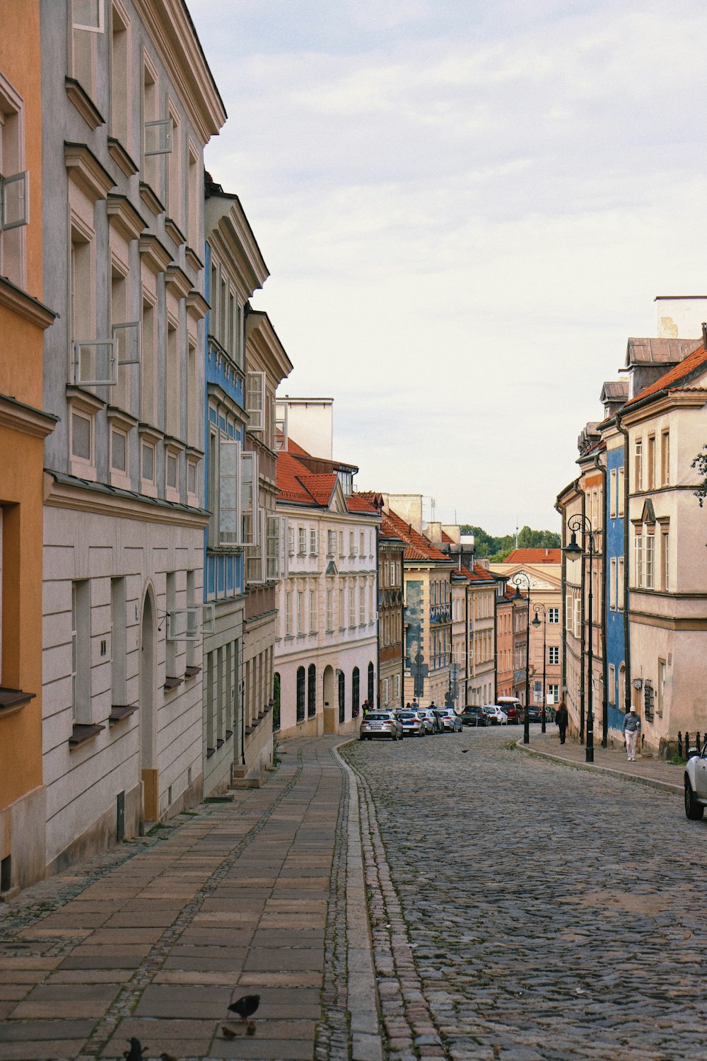 a cobblestone street with buildings on either side of it