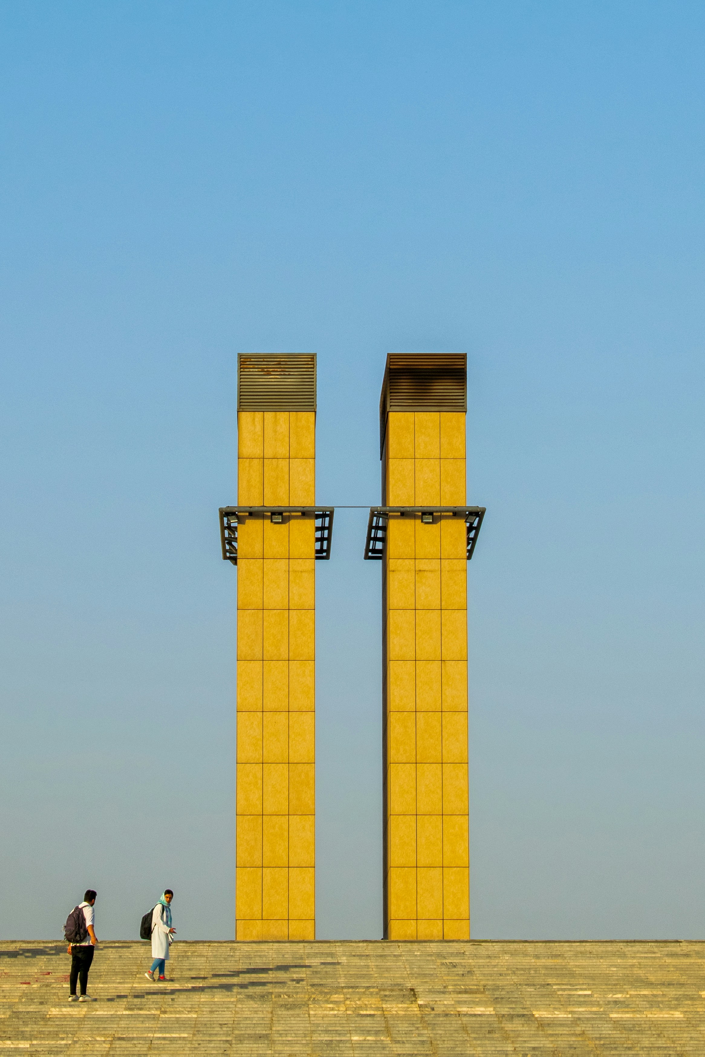 a group of people standing in front of a large tower