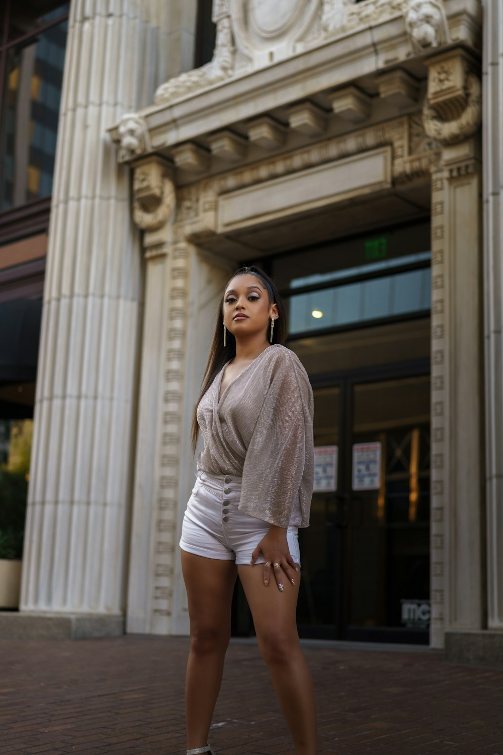 a woman posing in front of a building