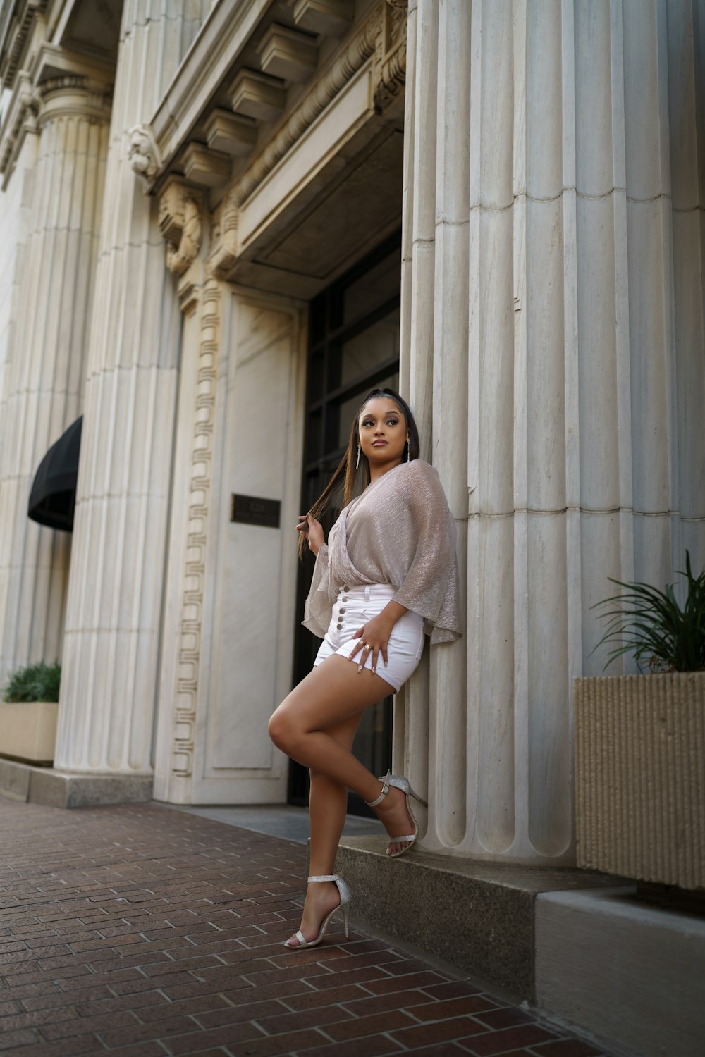 a woman posing in front of a building