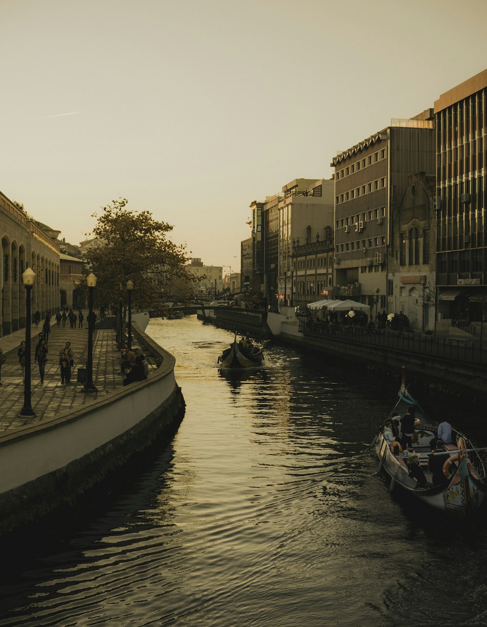 a small boat in a body of water with a city in the background