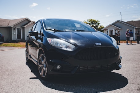 a black car parked in a driveway