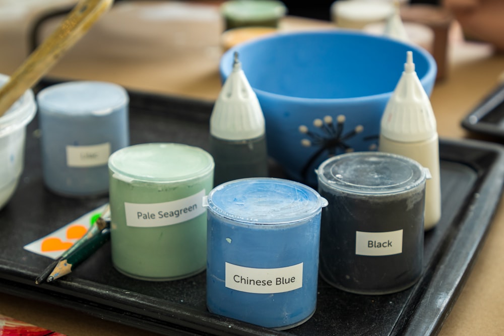 a group of containers with different colored liquids in them