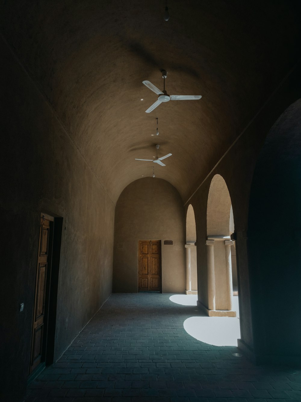 a hallway with a ceiling fan