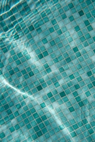 Close-up of textured ceramic tiles creating a wave effect in a pool.