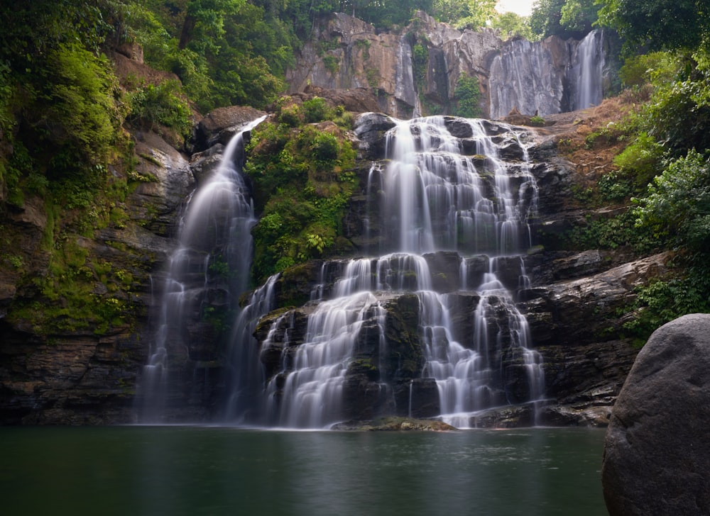 a waterfall over a body of water